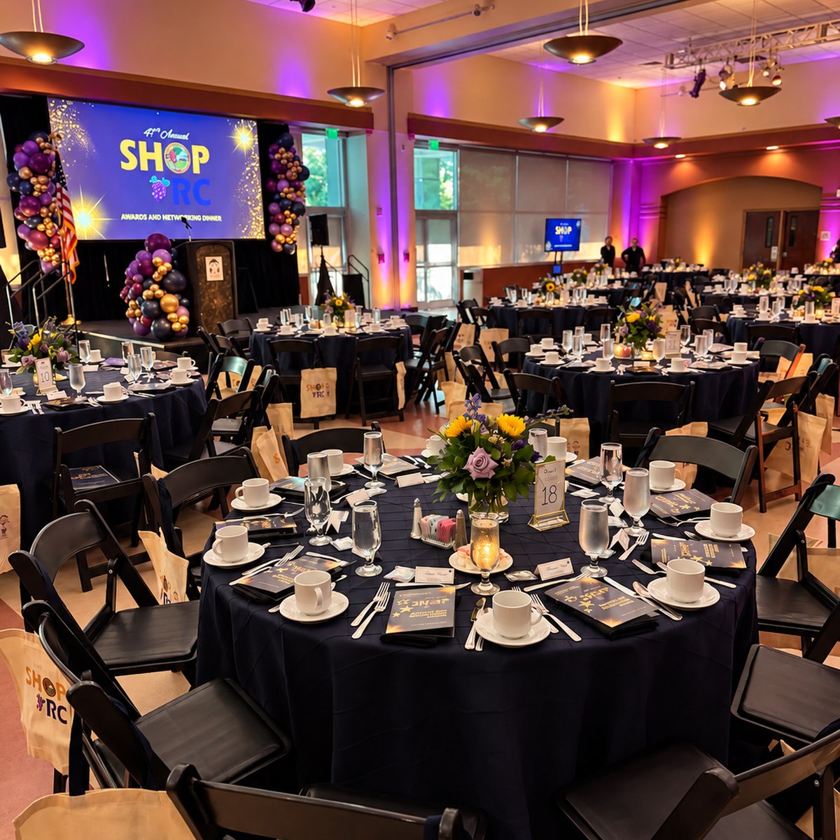 Awards and networking dinner with a stage and purple lighting