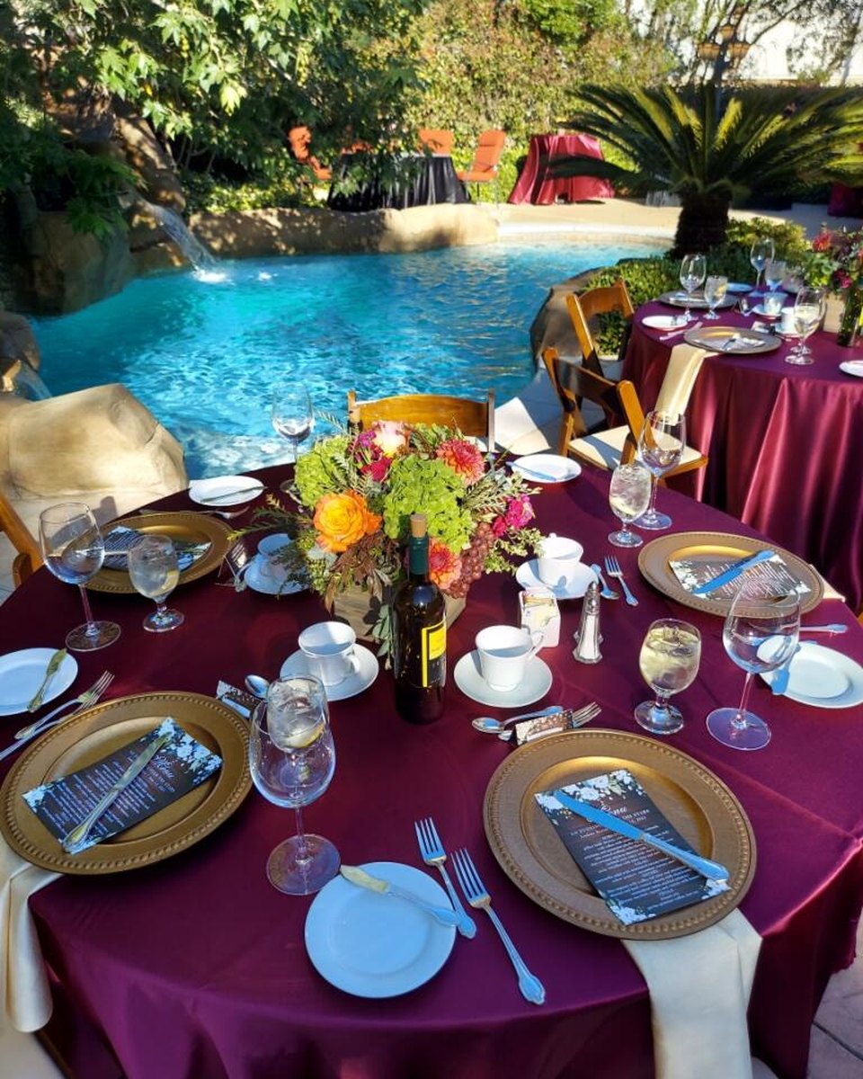 Poolside dinner table with burgundy linens